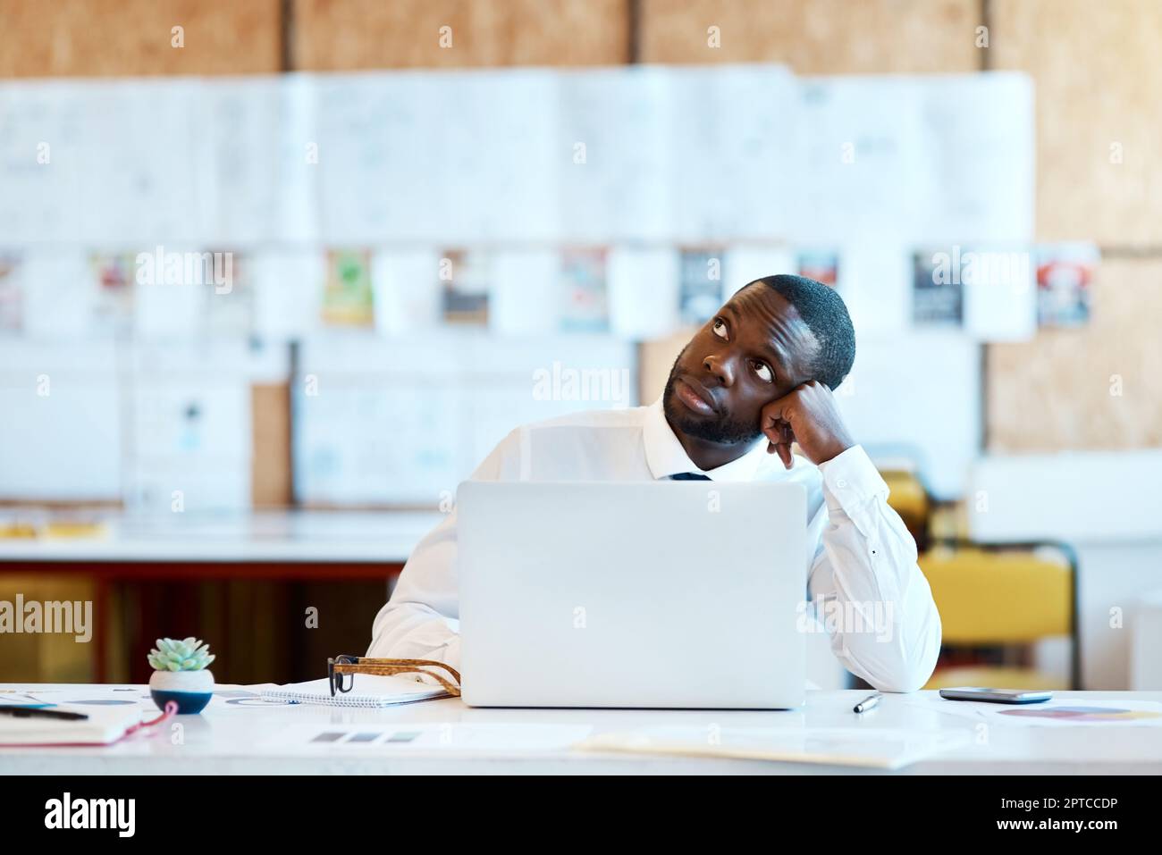Day dreaming a little bit. a focused young businessman typing on his