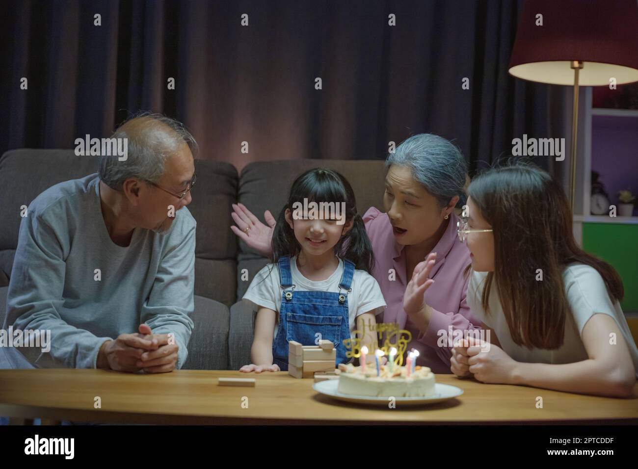 Birthday surprise. Happy Asian family grandparents and mother