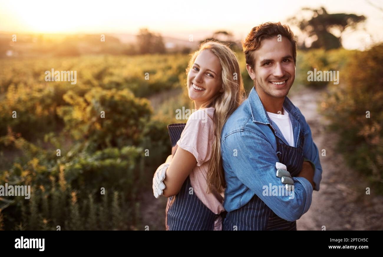 Were all riding the wave of the good food revolution. Portrait of a confident young man and woman working together on a farm Stock Photo
