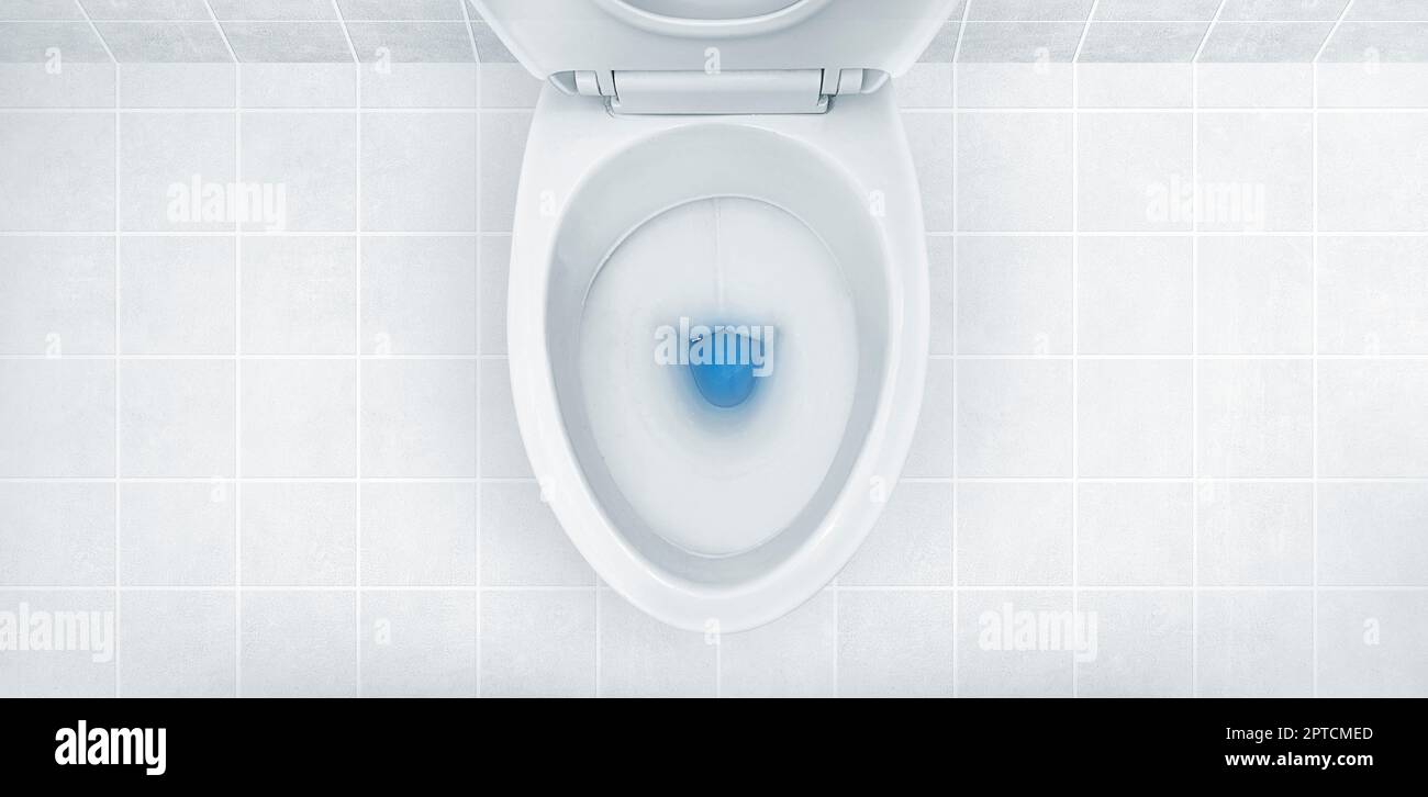 Top view of toilet bowl, blue detergent flushing in it Stock Photo Alamy