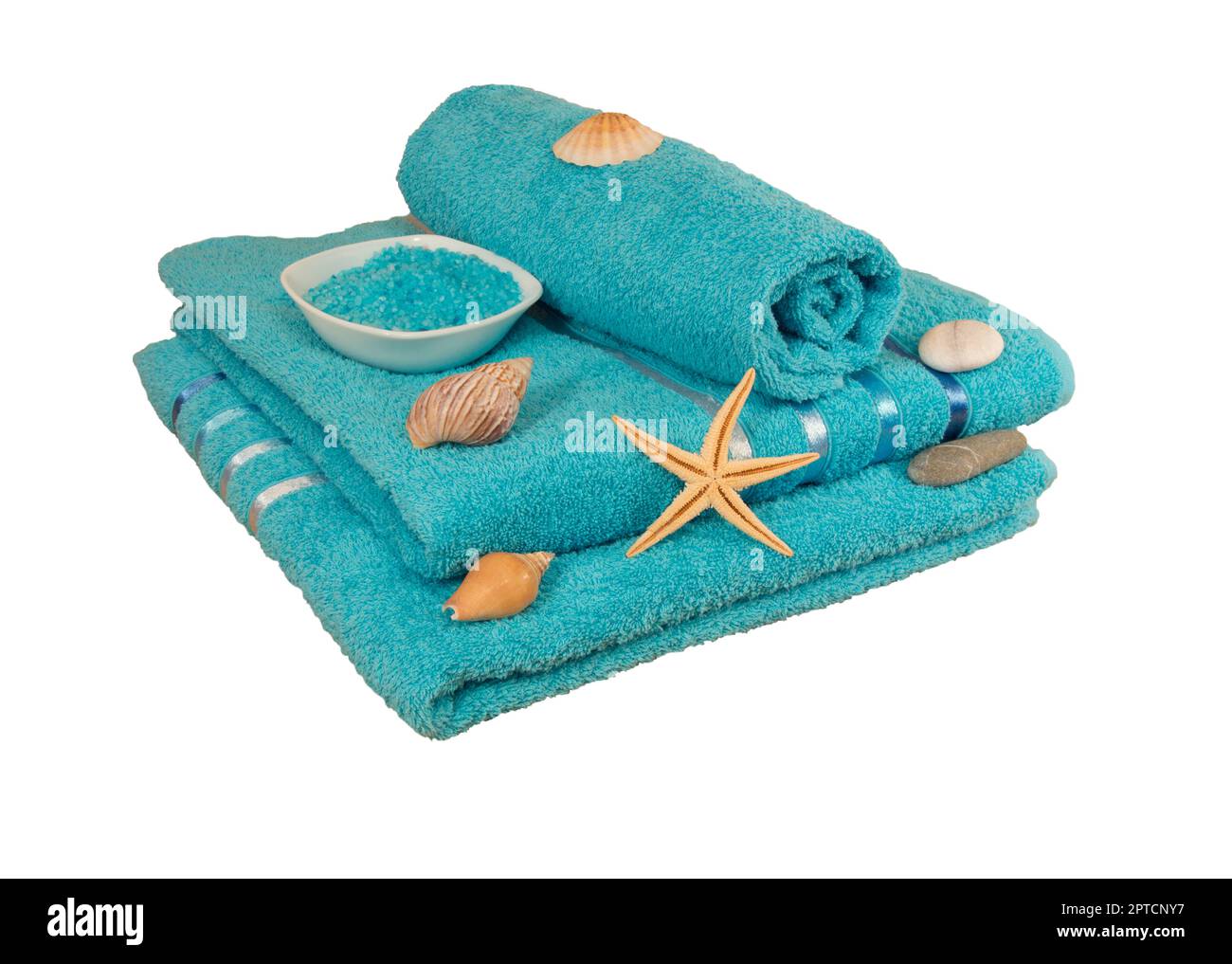sea salt Spa, folded stack of blue towels and seashells isolated on white background. Stock Photo