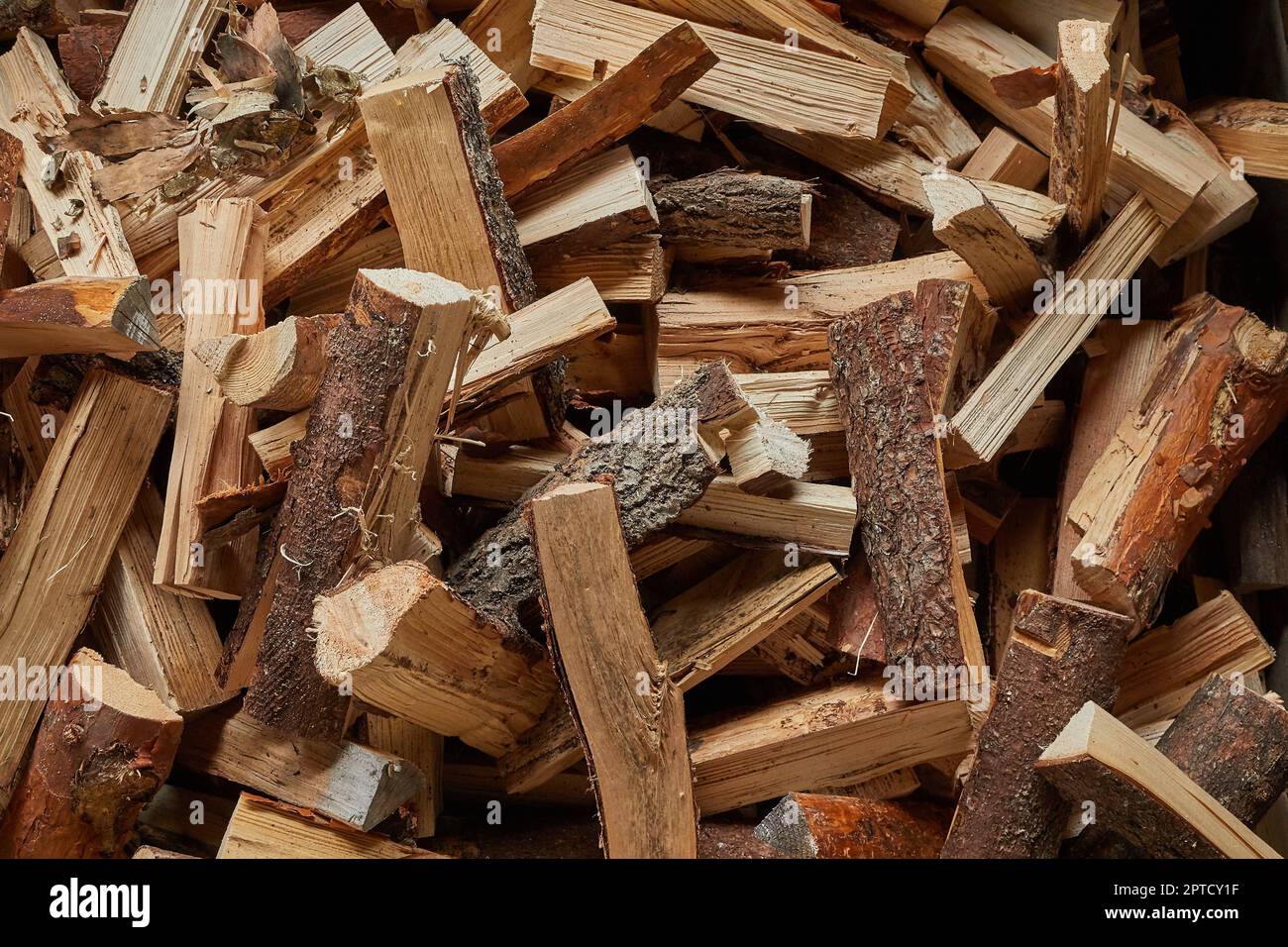 logs of wood in a pile ready to be cut and chopped for firewood in a  fireplace and boiler Stock Photo - Alamy
