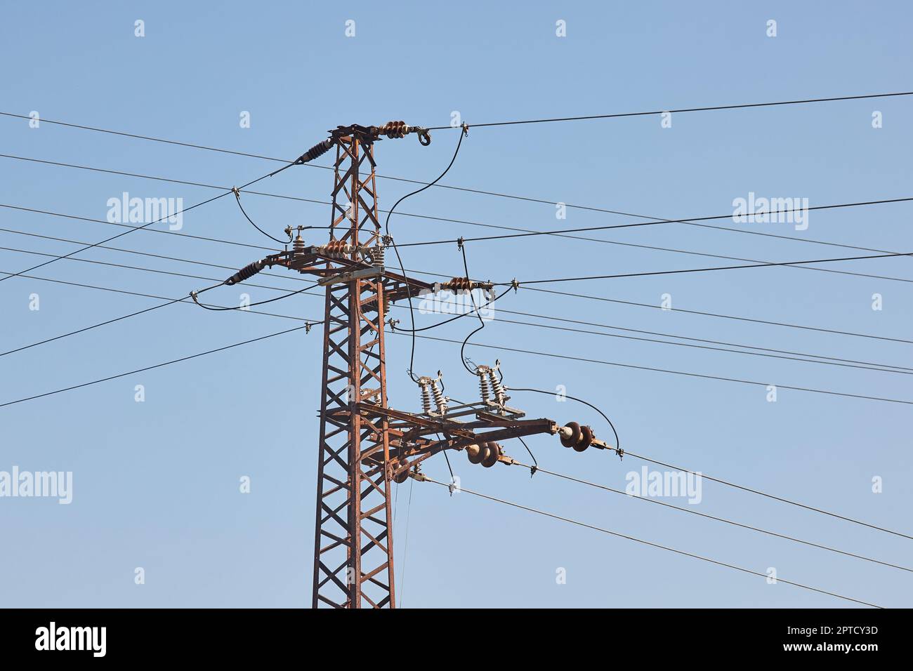 Electric lines overhaead, power line against blue sky Stock Photo - Alamy