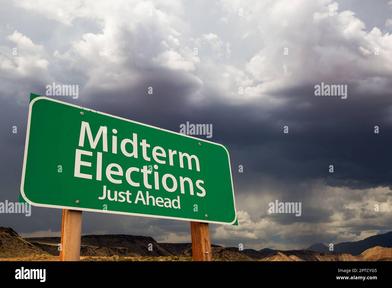 Midterm Elections Green Road Sign Over Dramatic Clouds and Sky. Stock Photo