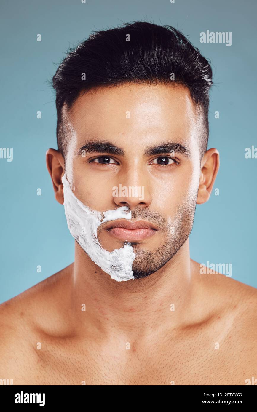 Portrait, skincare and man shaving in studio on blue background for