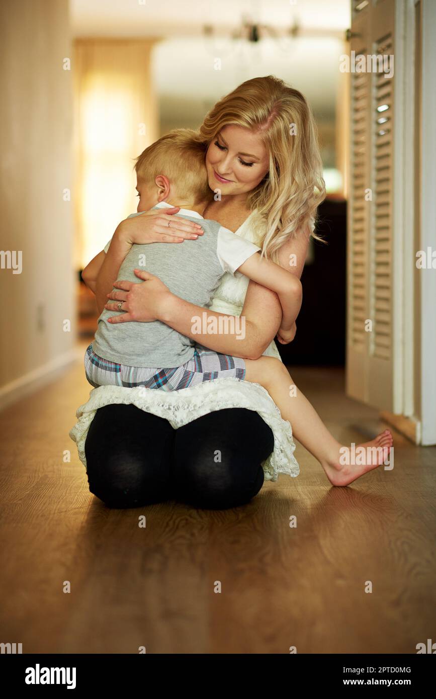 Moms cuddles are the most comforting. a little boy being comforted by