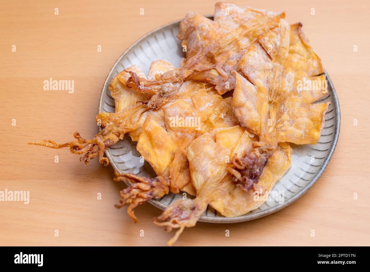 Dried squid snack in the plate Stock Photo - Alamy