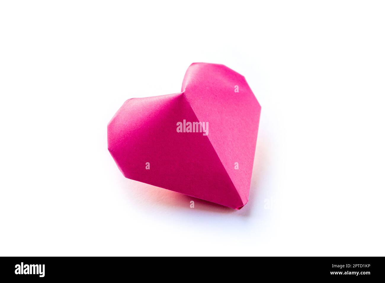 Pink paper heart origami isolated on a blank white background ...