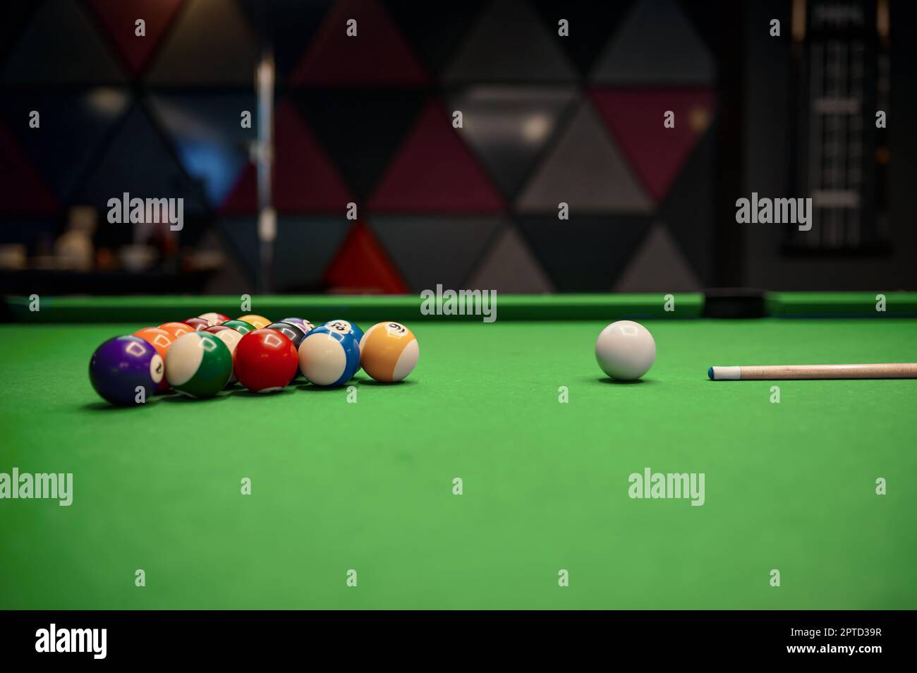 Green billiard table with balls and cue prepared for sport pool game