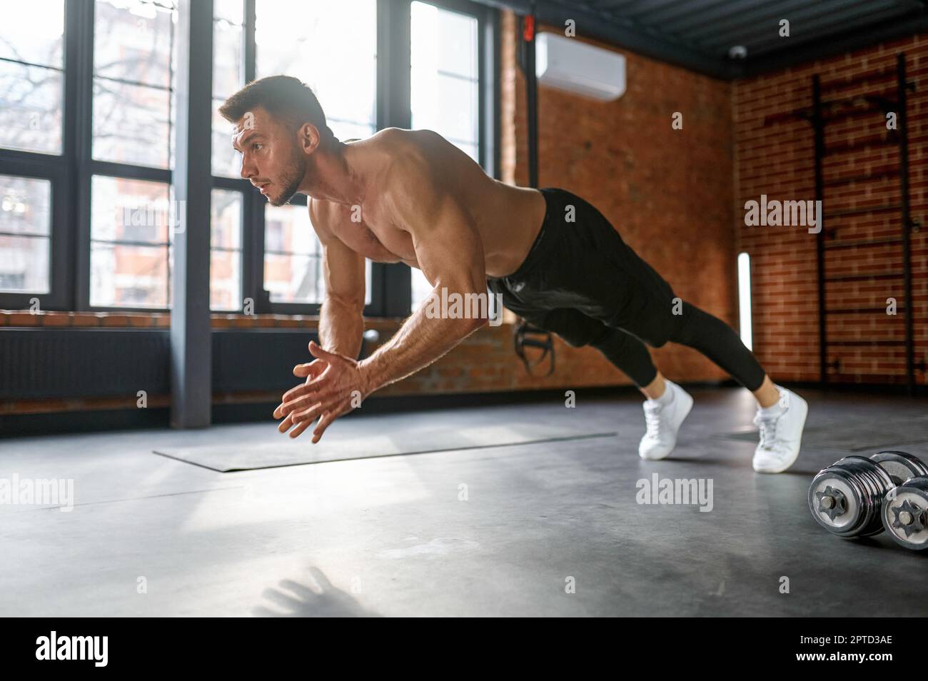Sportsman doing clapping pushups exercise at gym sport club. Explosive strength training