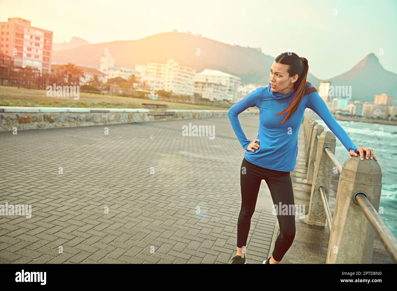 boring laps around a track. a sporty young woman taking a break