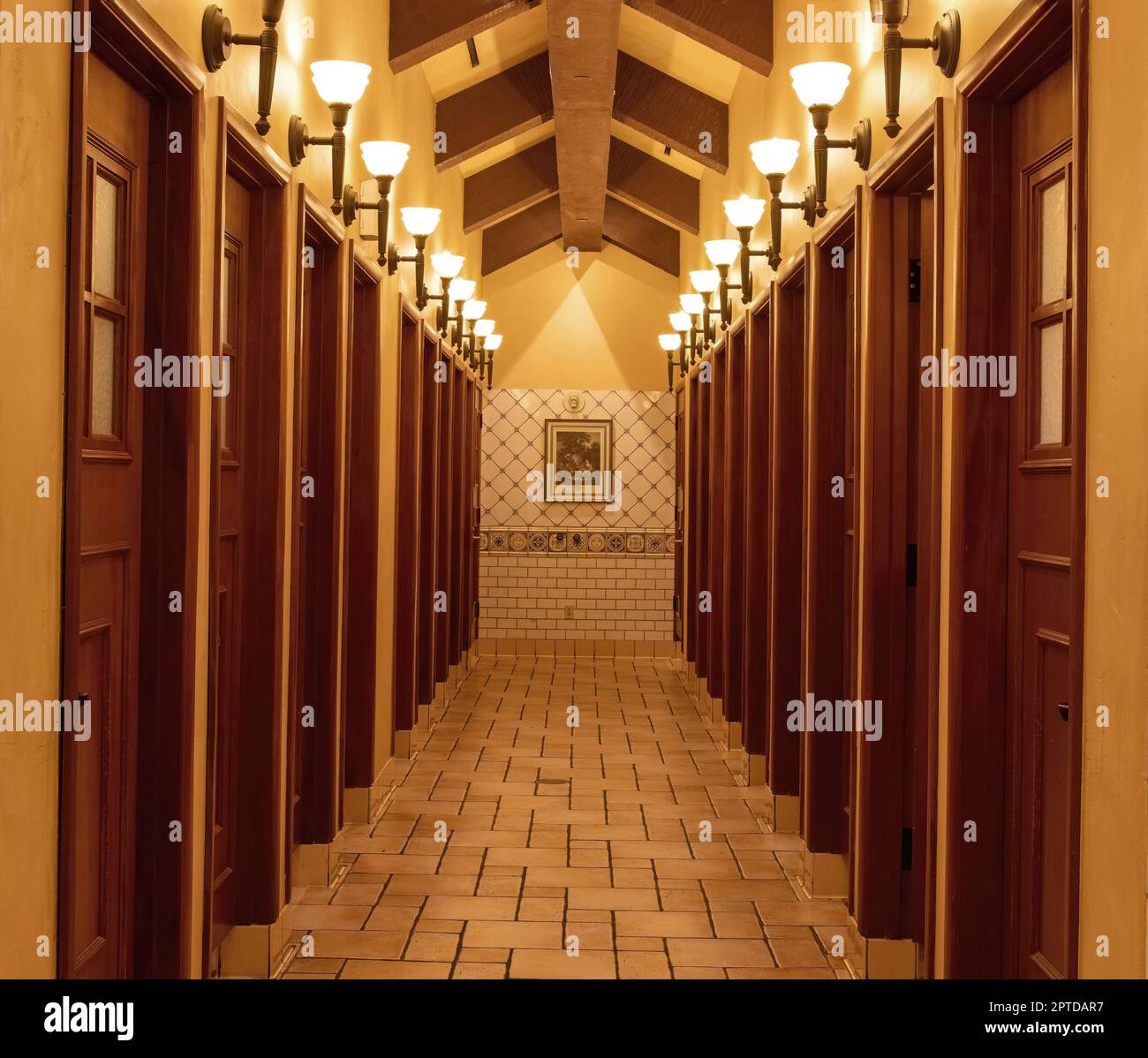 Beautiful bathroom with a long hallway of stalls and lights, with a beam ceiling at the Paris Las Vegas Hotel and Casino, in Las Vegas, Nevada USA. Stock Photo