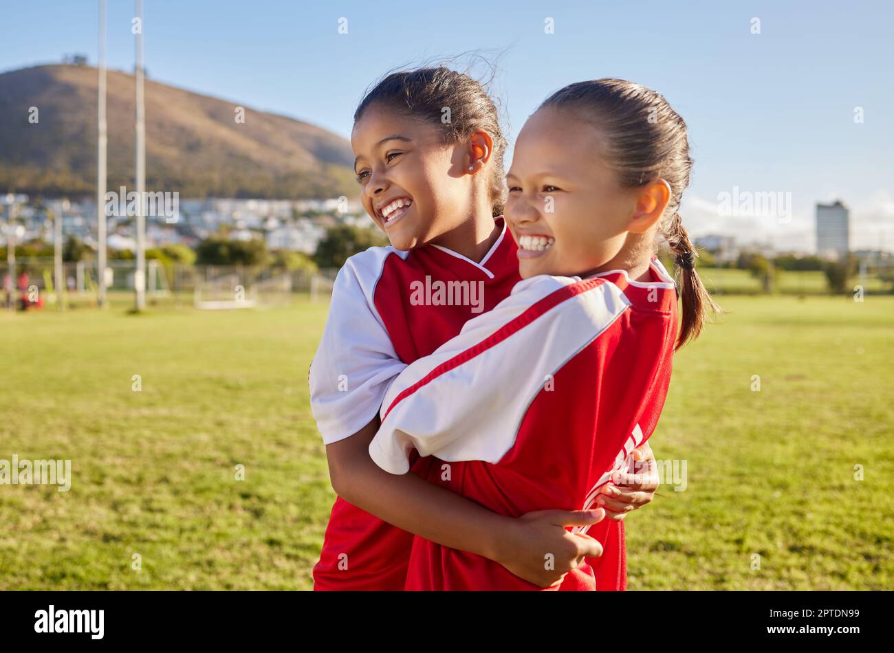 Football, girl and sports children hug, smile and happy together having