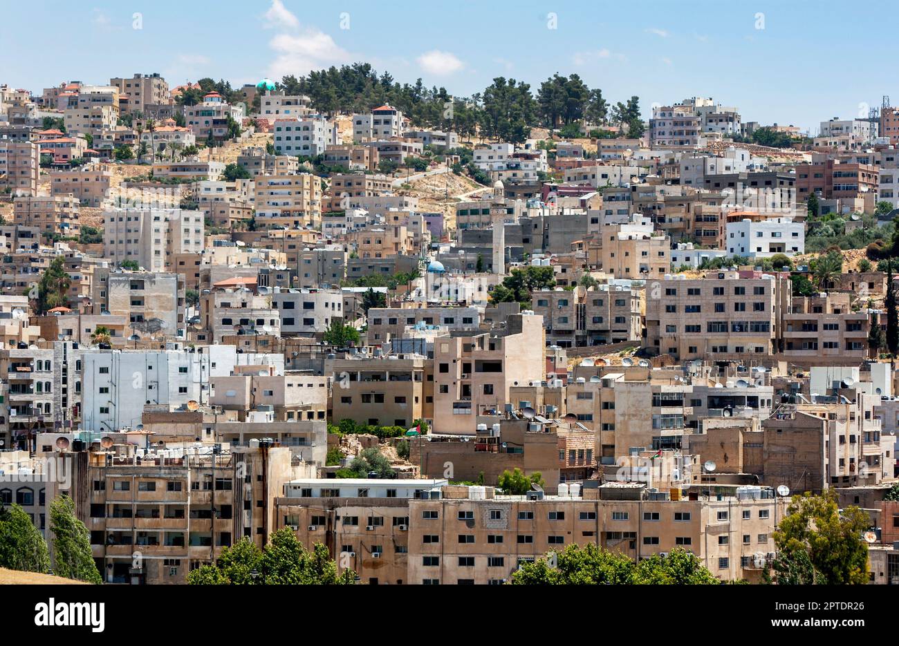 A section of apartment buildings sitting on a hillside in the modern city of Jerash in Jordan