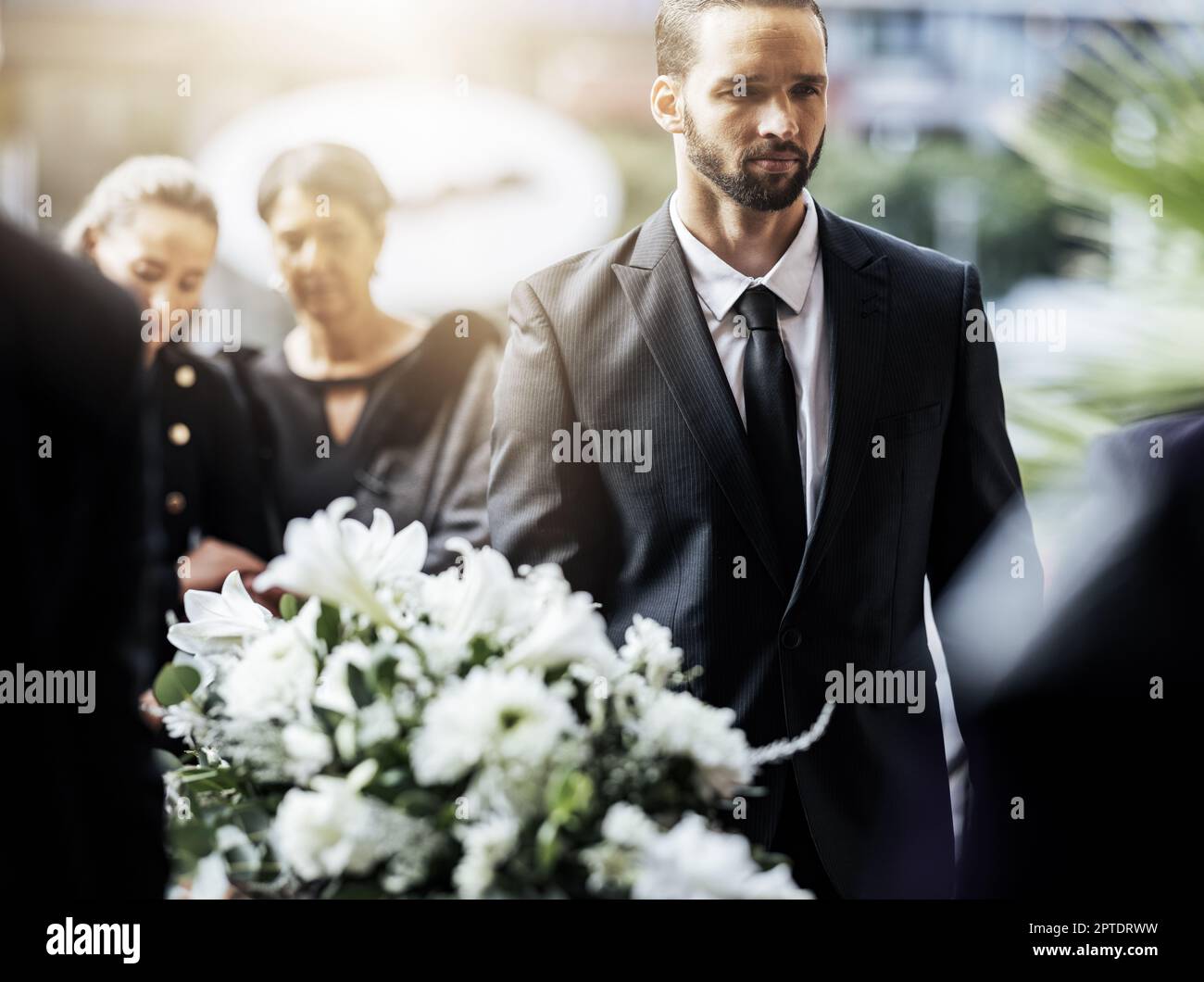 Death, funeral and carry coffin with family mourning, sad and depressed
