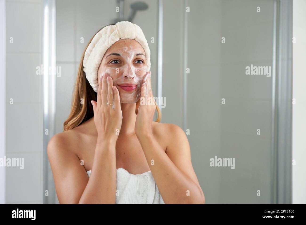 Skincare woman washing face foaming soap scrubbing skin. Face wash exfoliation scrub soap woman washing scrubbing with skincare cleansing product. Enj Stock Photo