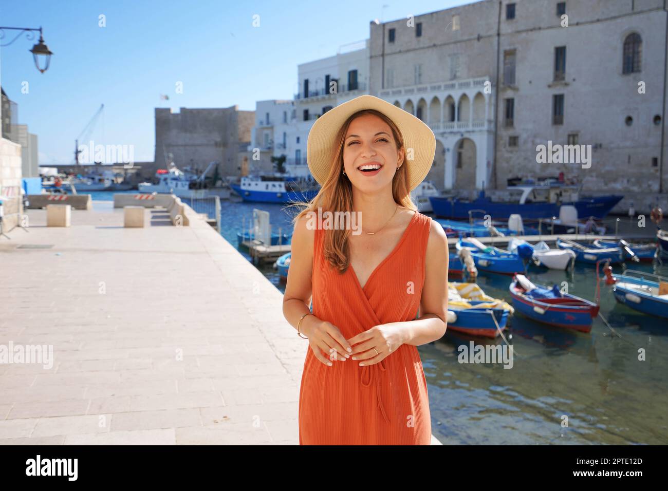 Vacation in Italy. Portrait of tourist woman have fun laughing in historic town of Apulia, Italy. Stock Photo