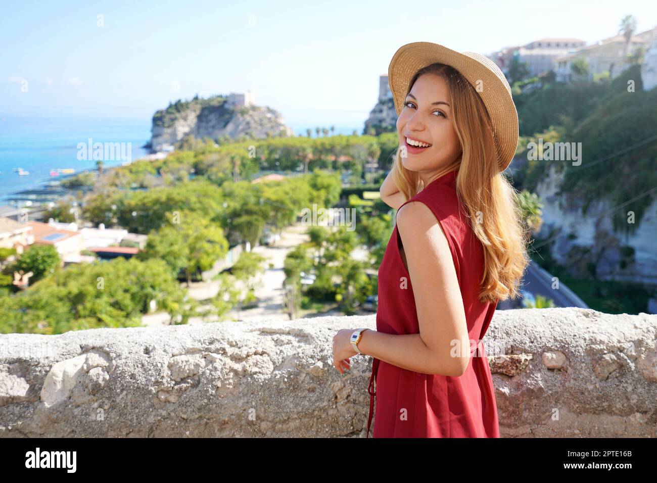 Portrait of attractive fashion model turns around to the camera in Tropea village, Calabria, Italy Stock Photo