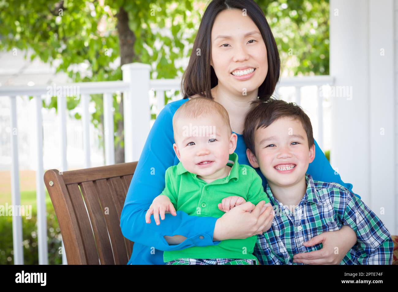 Outdoor Portrait of A Chinese Mother with Her Two Mixed Race Chinese and Caucasian Young Boys Stock Photo