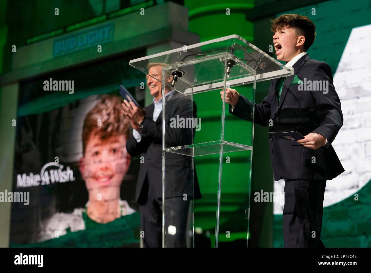 Cancer survivor Kyle Stickles, right, who is a MakeAWish kid, walks