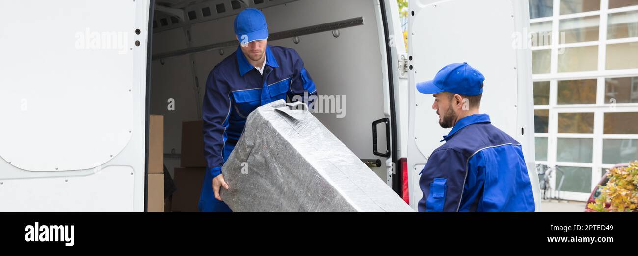 Furniture Mover Unloading Truck. Relocation Delivery Load Stock Photo