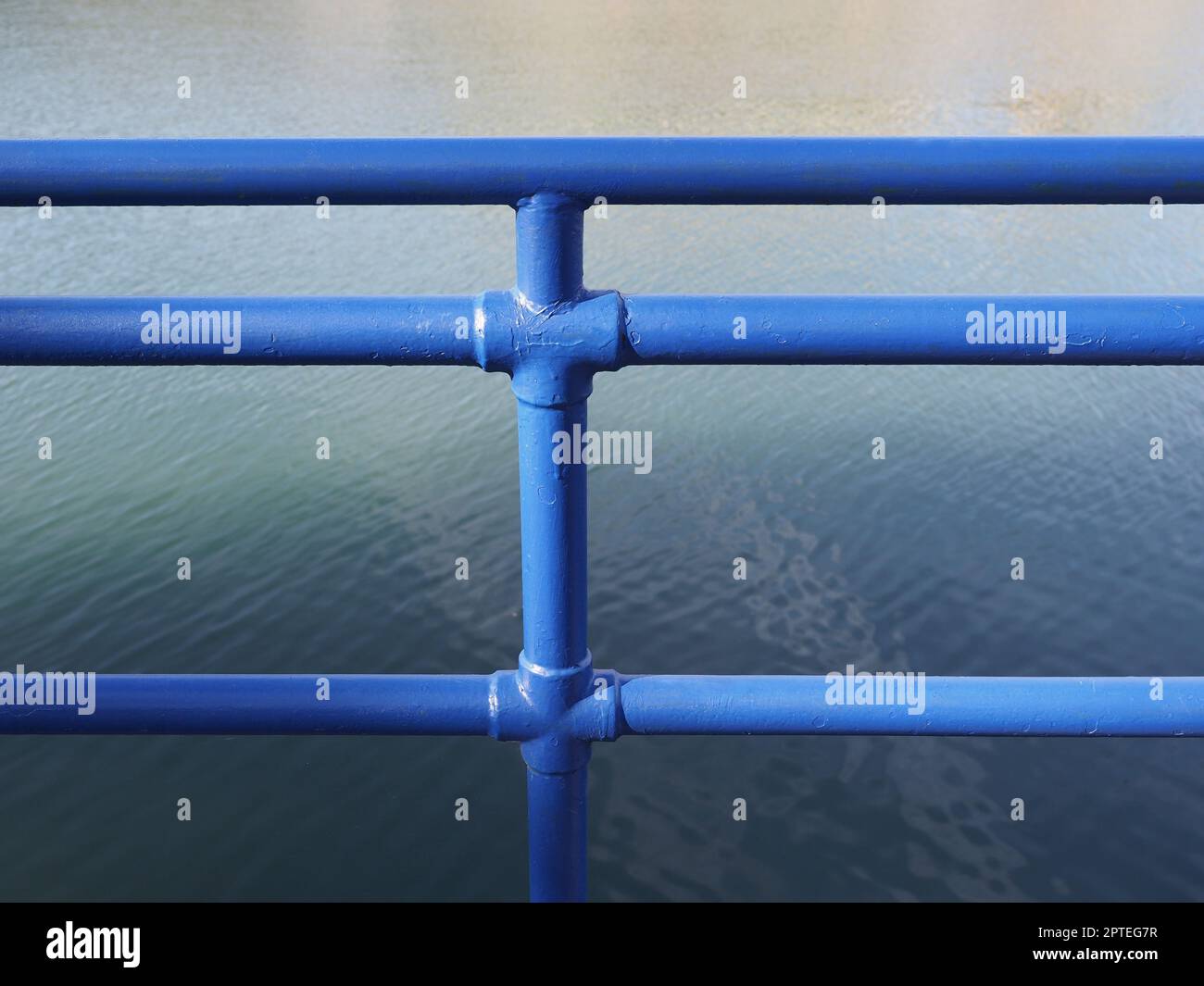 Blue metal fence on the river bank Stock Photo - Alamy