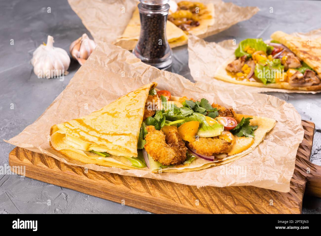 Pancake or crepe with fried shrimp tomatoes and vegetables Stock Photo