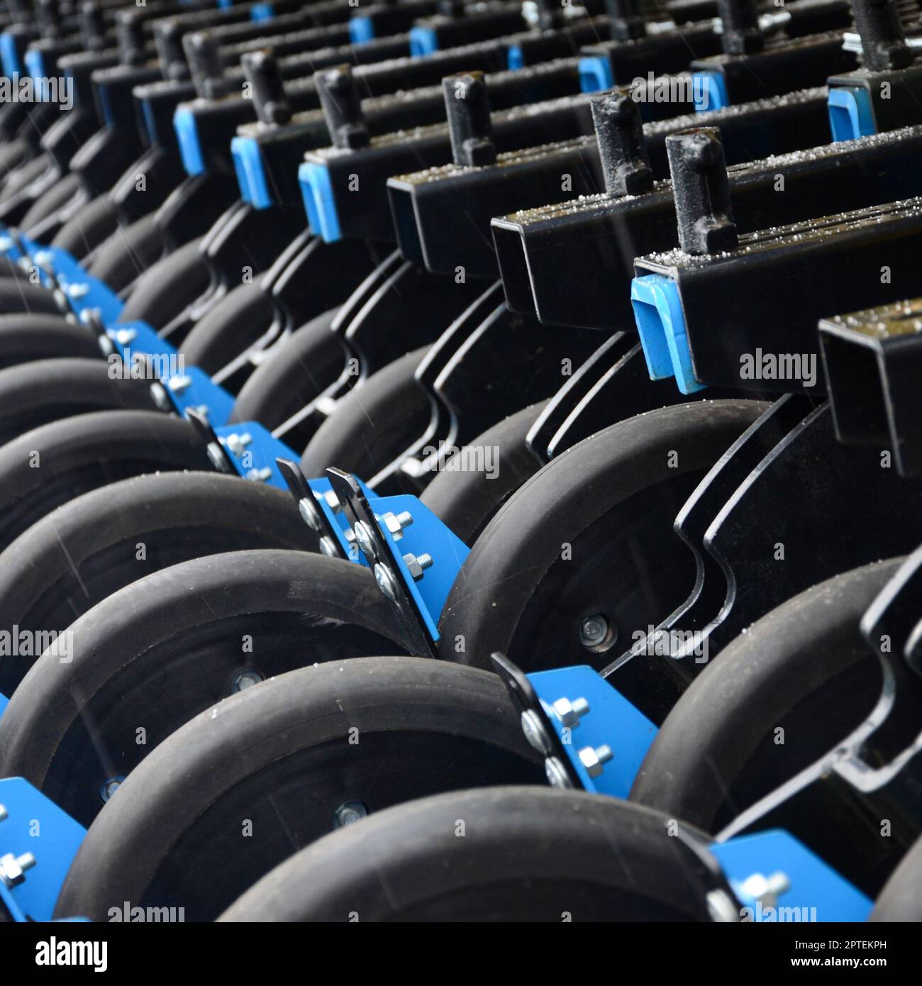 Row of wheels of the new industrial agricultural seeder close up Stock