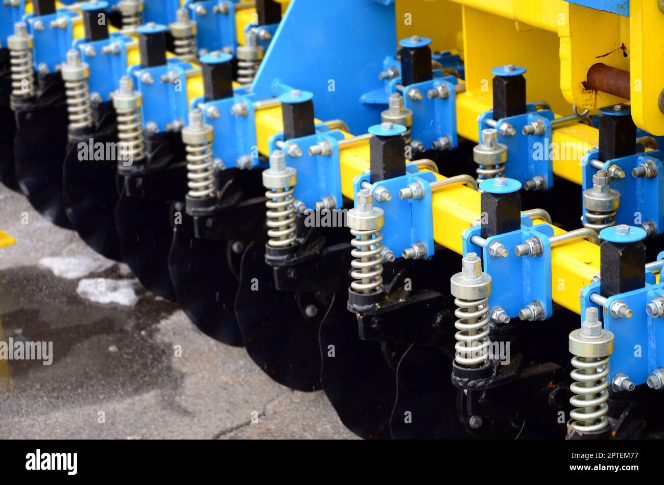 Spring system of agricultural seeder close up Stock Photo - Alamy