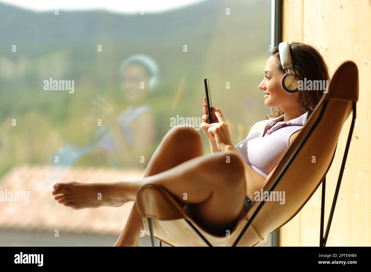 Young beautiful girl in panties and t-shirt listening to music in the  kitchen and cooking. Young female with headphones on the kitchen. Stock  Photo by ©flowertiare 153509830