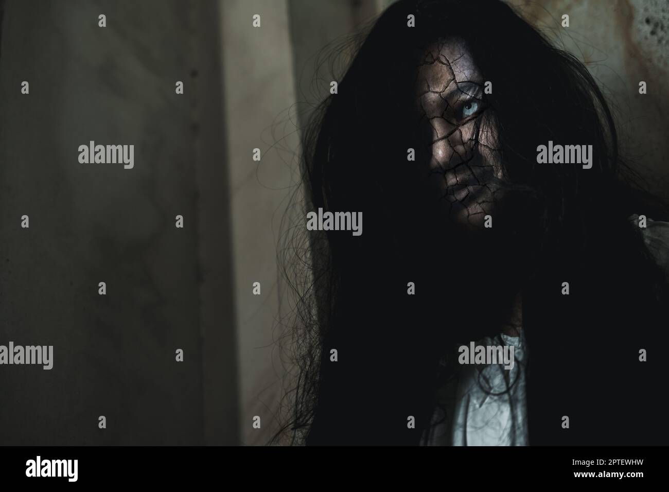 Scary ghost woman. Close up face of Asian woman ghost or zombie horror creepy scary have hair covering the face her eye at abandoned dark tone, female Stock Photo