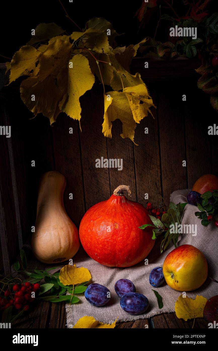 Various fruits in a wooden box with autumn leaves Stock Photo - Alamy