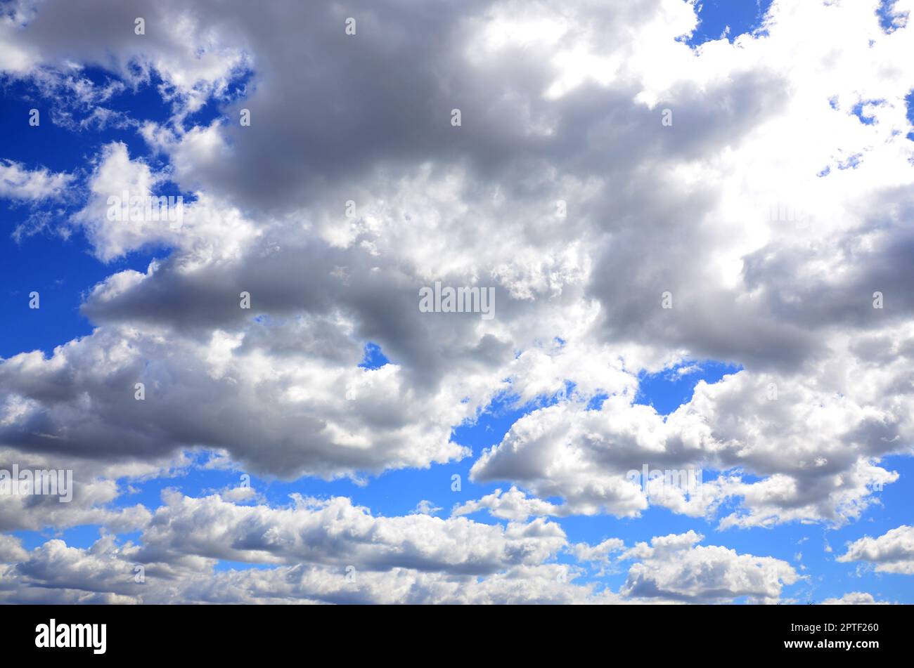 A blue sky with lots of white clouds of different sizes Stock Photo - Alamy