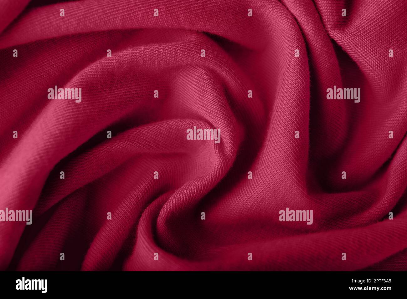 Crumpled knitted viva magenta fabric, closeup Stock Photo