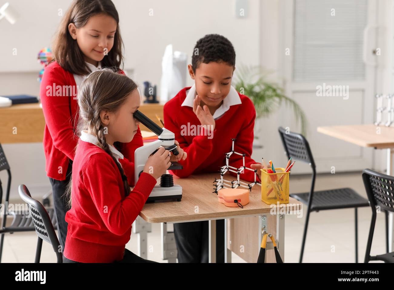 Little children with microscope having Chemistry lesson in science ...