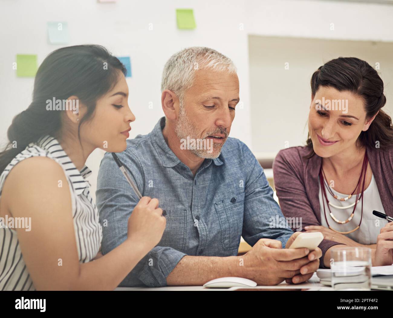 Pitching ideas for a new mobile app. a team of colleagues having a ...