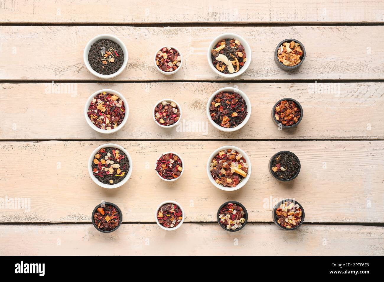 Assortment with different types of dried fruit tea on white wooden
