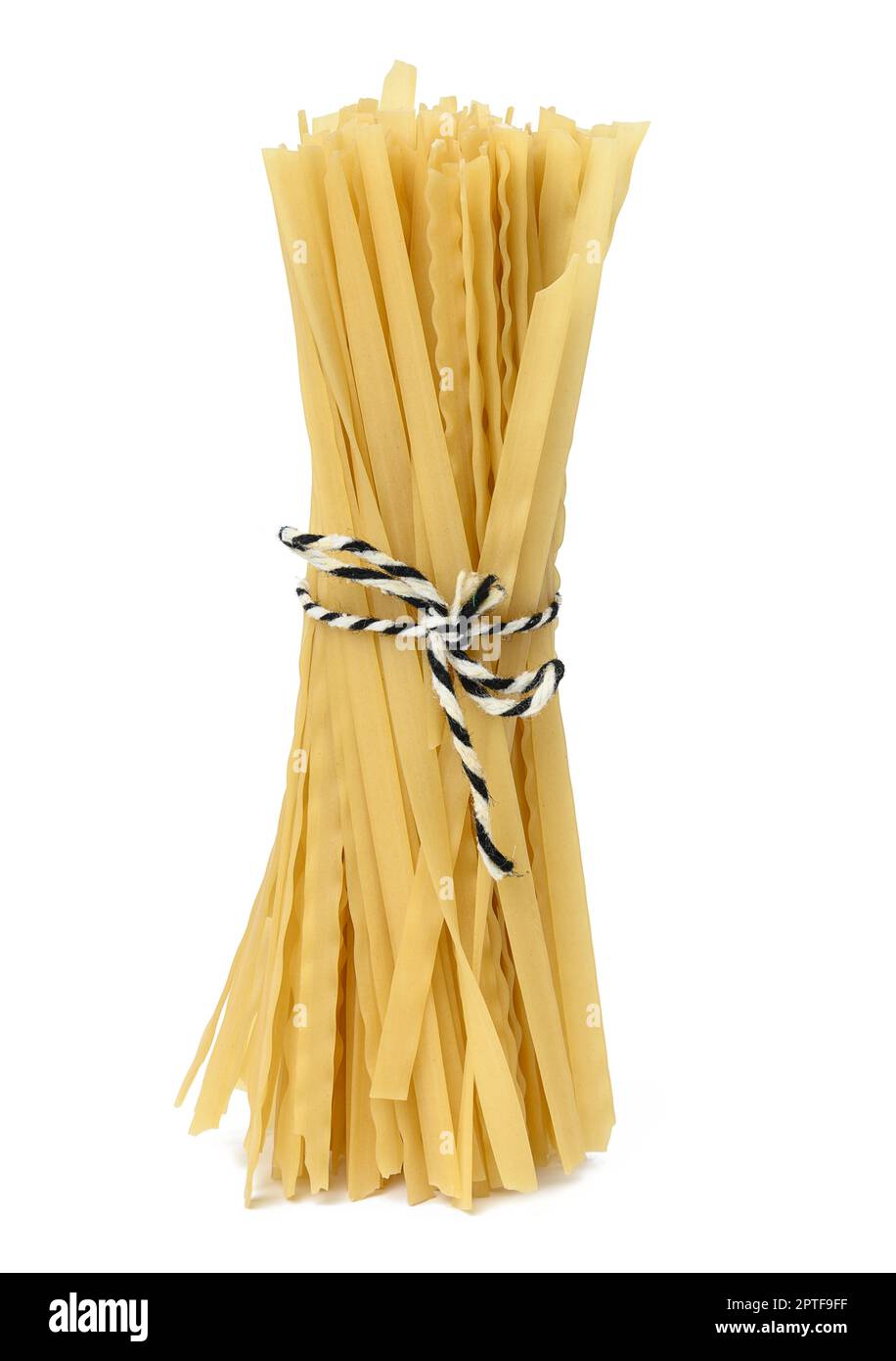 Raw long pasta tied with a rope on a white isolated background Stock Photo