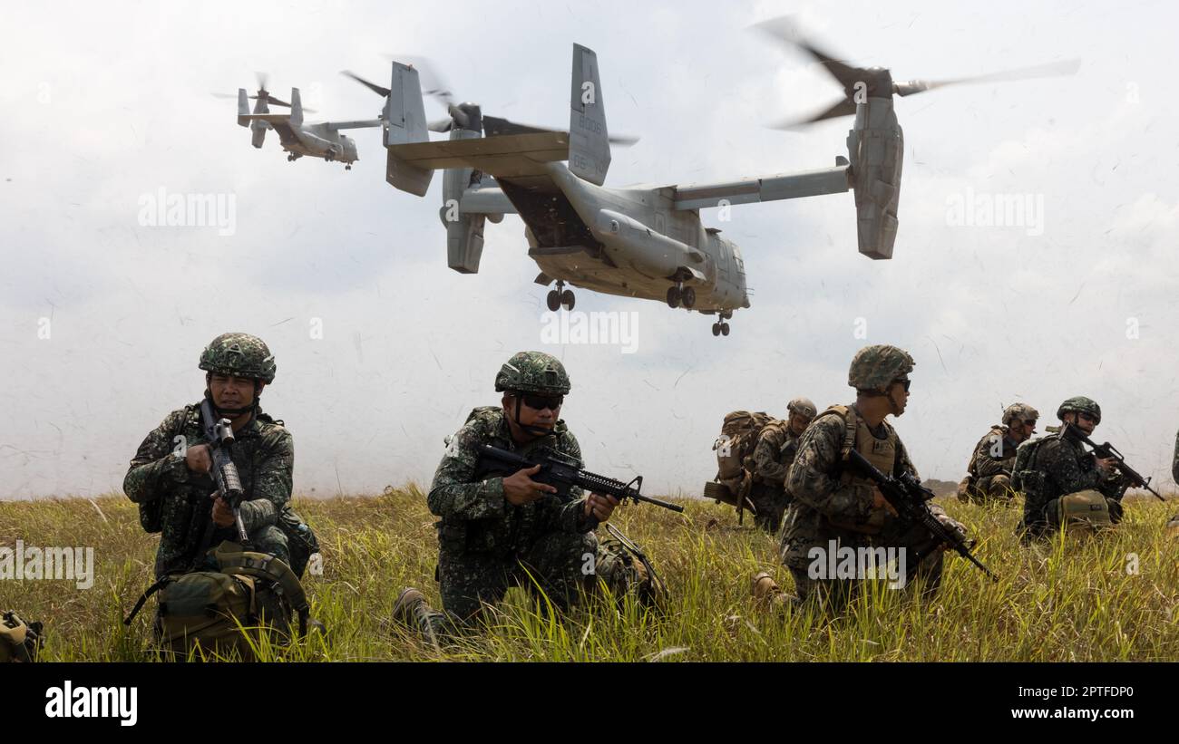 U.S. Marines, with 3d Littoral Combat Team, 3d Marine Littoral Regiment, 3d Marine Division, and Philippine Marines with Battalion Landing Team 10, secure a landing zone for MV-22B Ospreys with Marine Medium