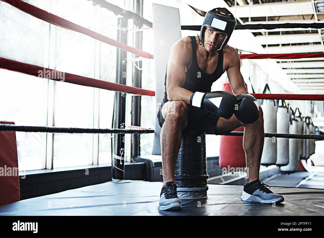 The best of the boxing beasts. a young man training in a boxing ring ...