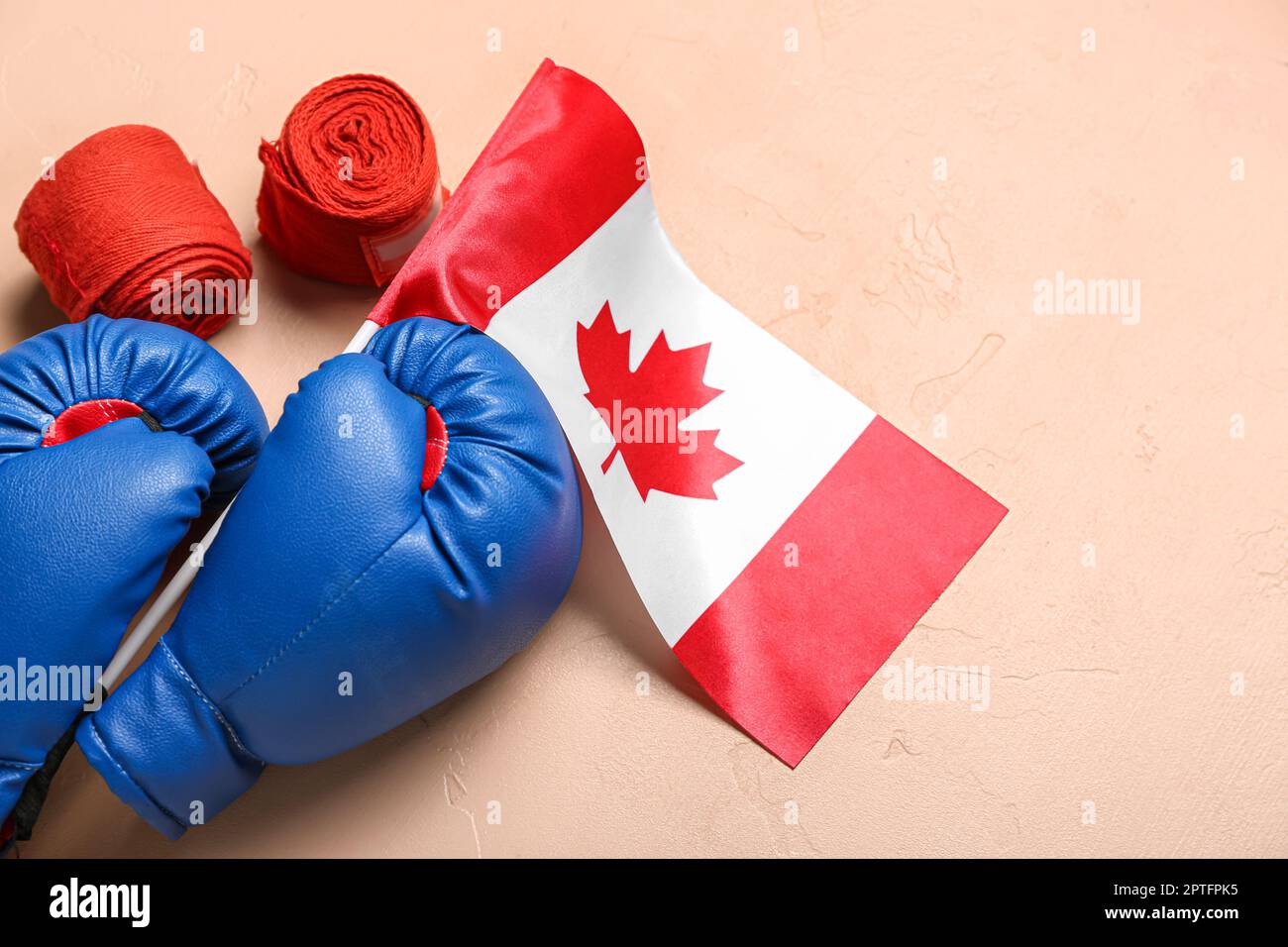Flag of Canada with boxing gloves and bandages on beige background ...