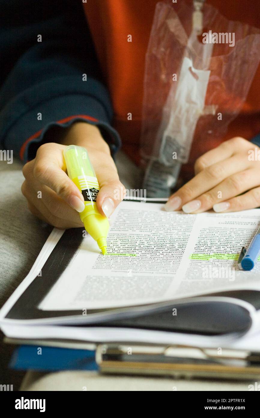 Highlighting. a student highlighting text while studying Stock Photo