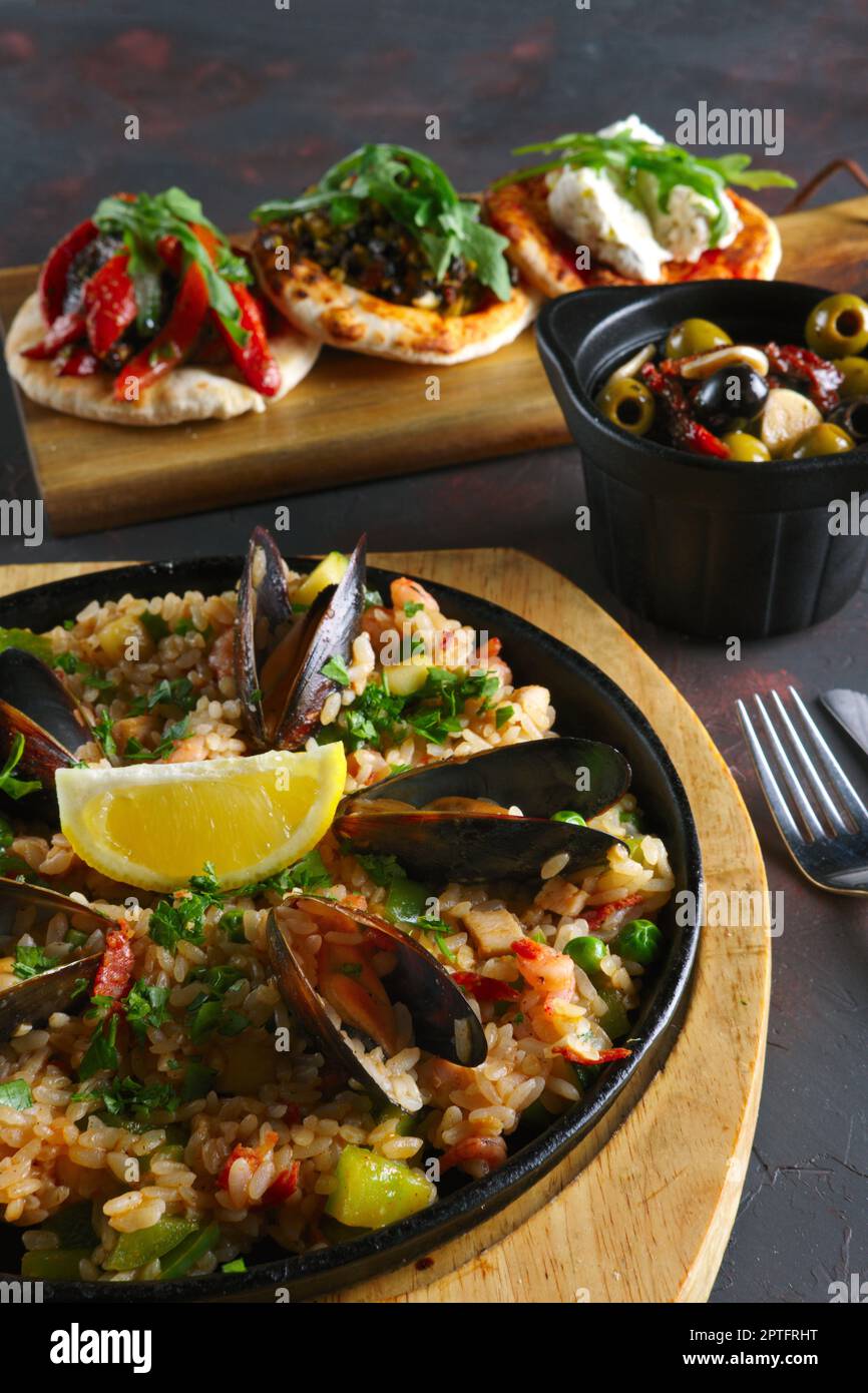 Set of tapas and paella with shrimps and mussels Stock Photo