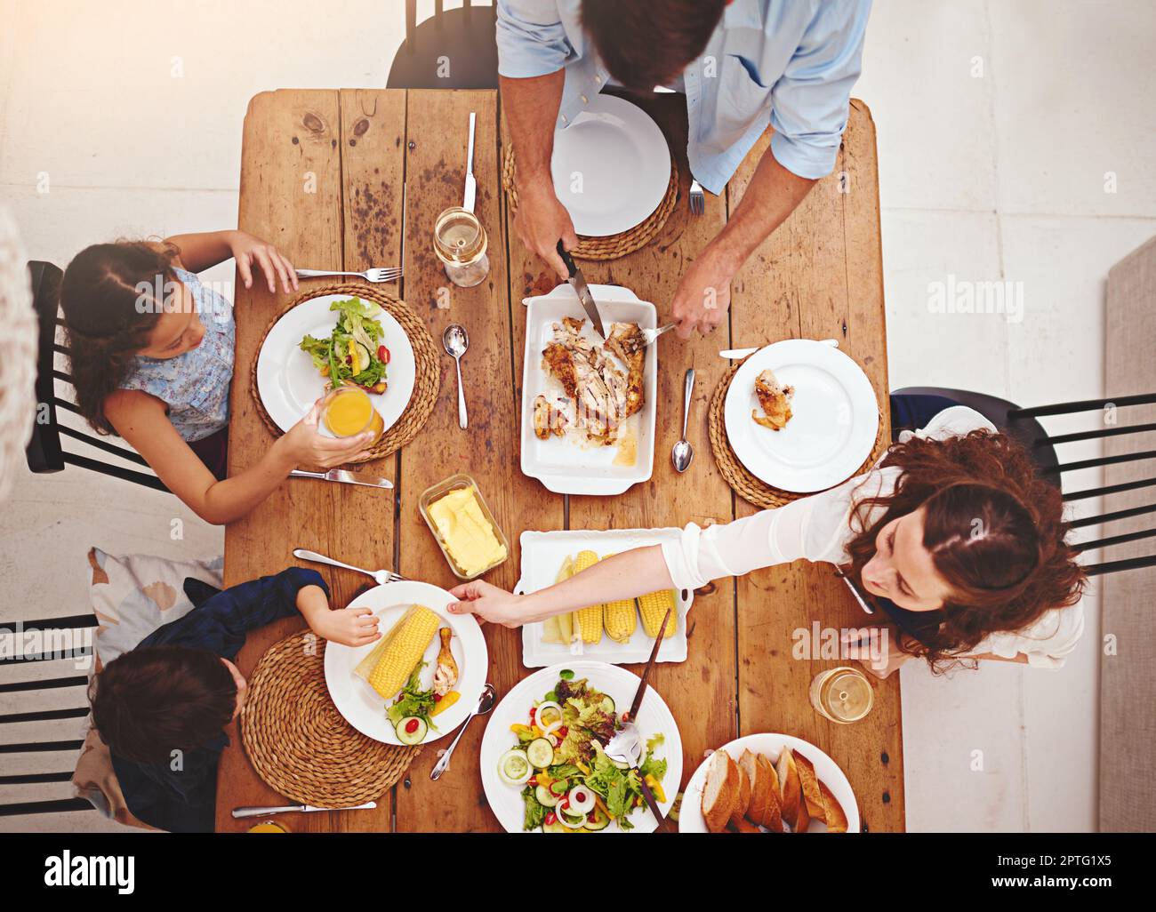 Mother makes sure that everyone has. High angle shot of a family eating