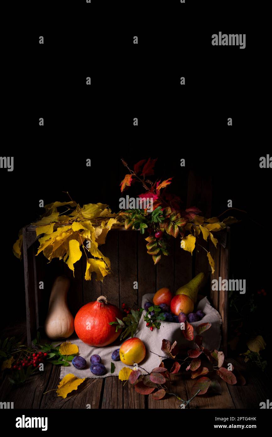 Various fruits in a wooden box with autumn leaves Stock Photo - Alamy