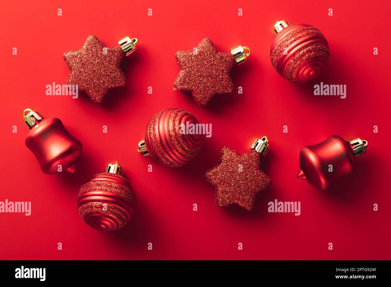 Red christmas decoration. Christmas bulbs on the red background. Top view. Stock Photo