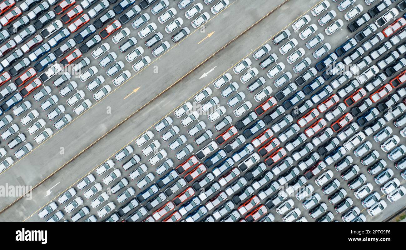 Aerial view of new cars stock at factory parking lot. Above view many