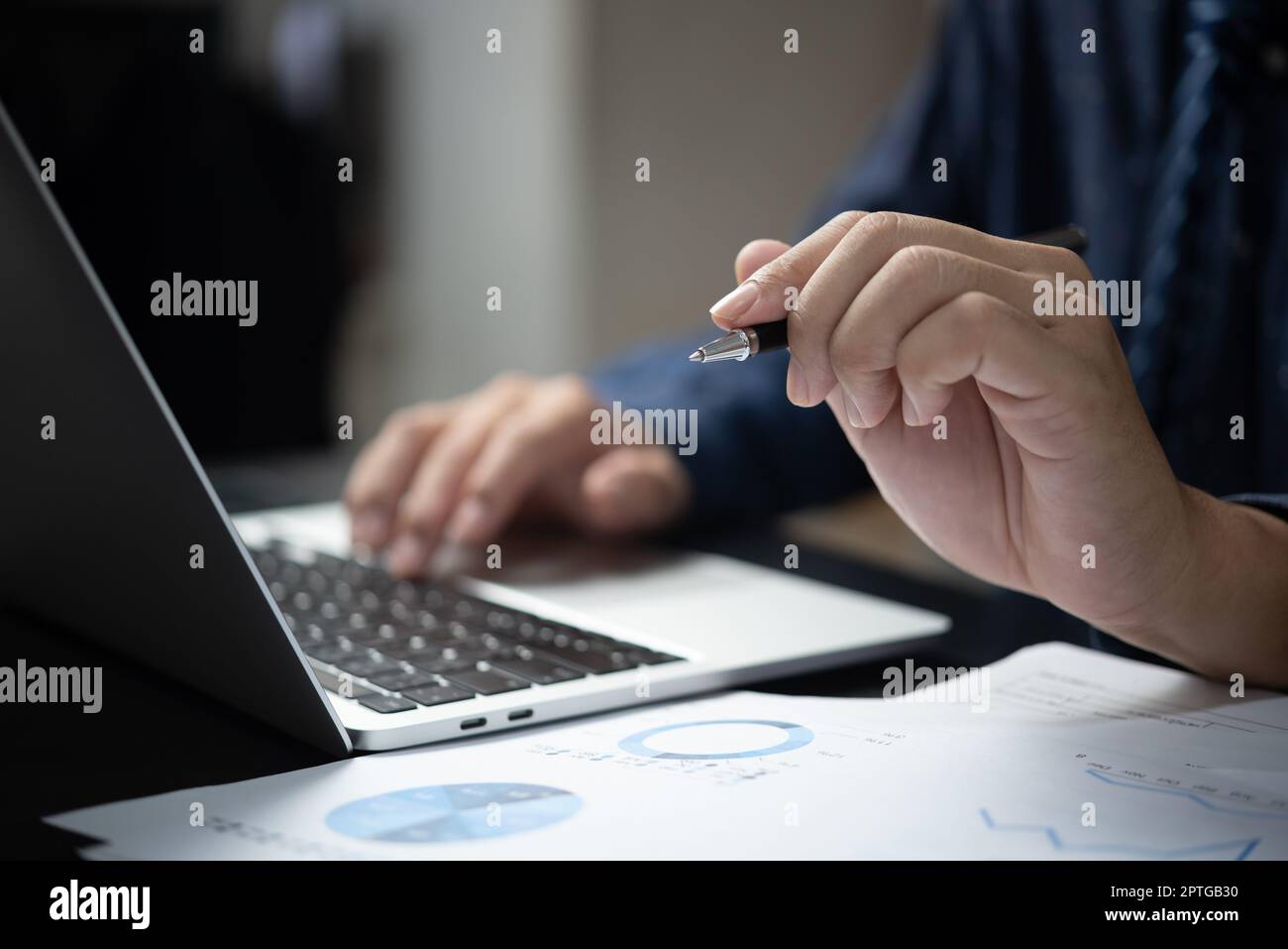 Hand holding pen document graph and chart report finance investment ...