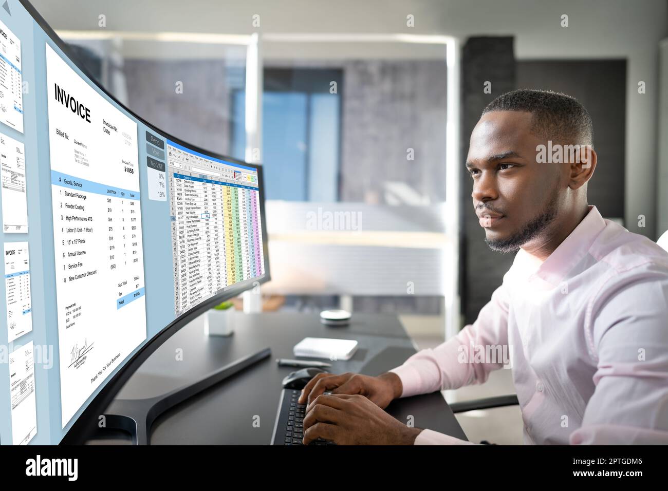 Looking At Invoice And Spreadsheet On Computer At Work Stock Photo