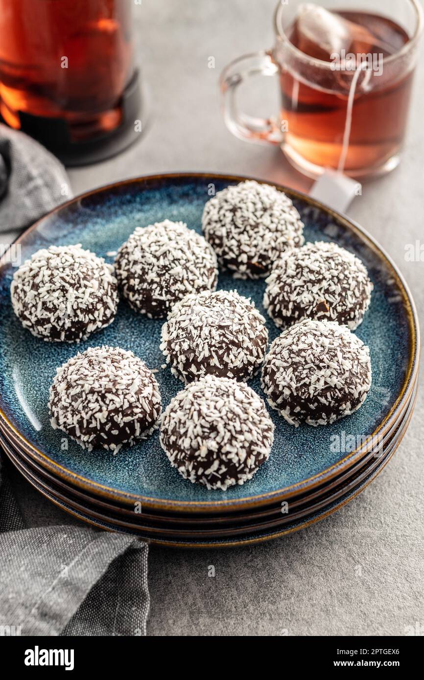 Coconut chocolate balls on plate on the kitchen table. Stock Photo